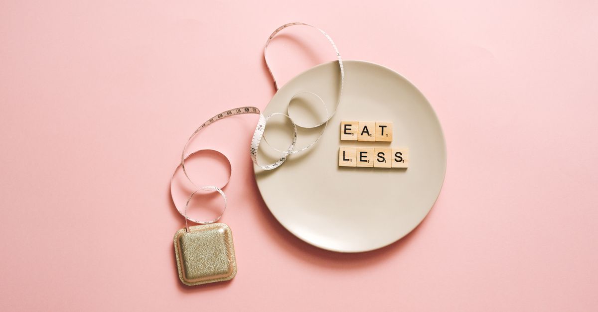 A motivational image featuring a plate with scrabble tiles spelling 'Eat Less' on a pink background.
